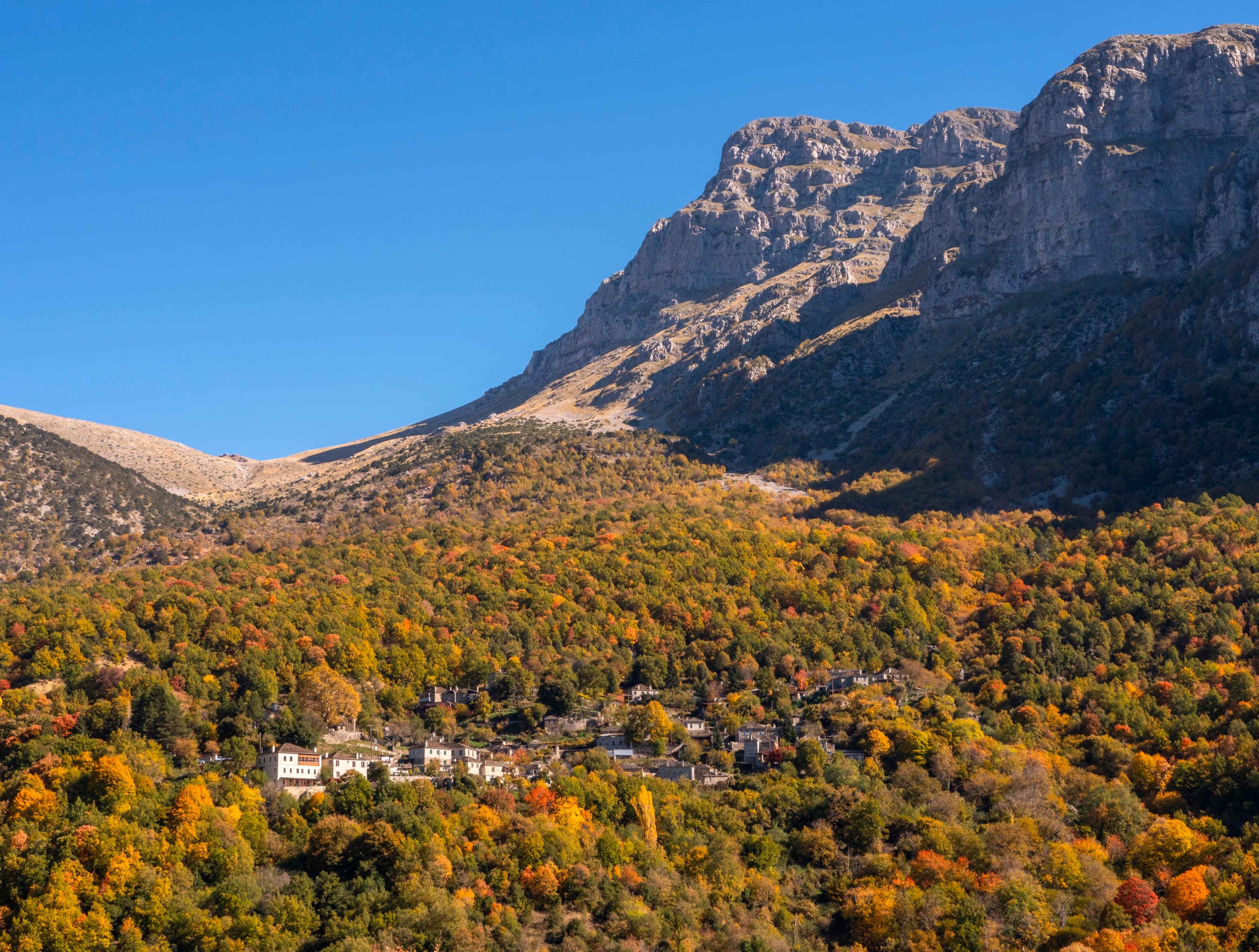 The stone village of Papigko beneath the limestone peaks of the Pindus